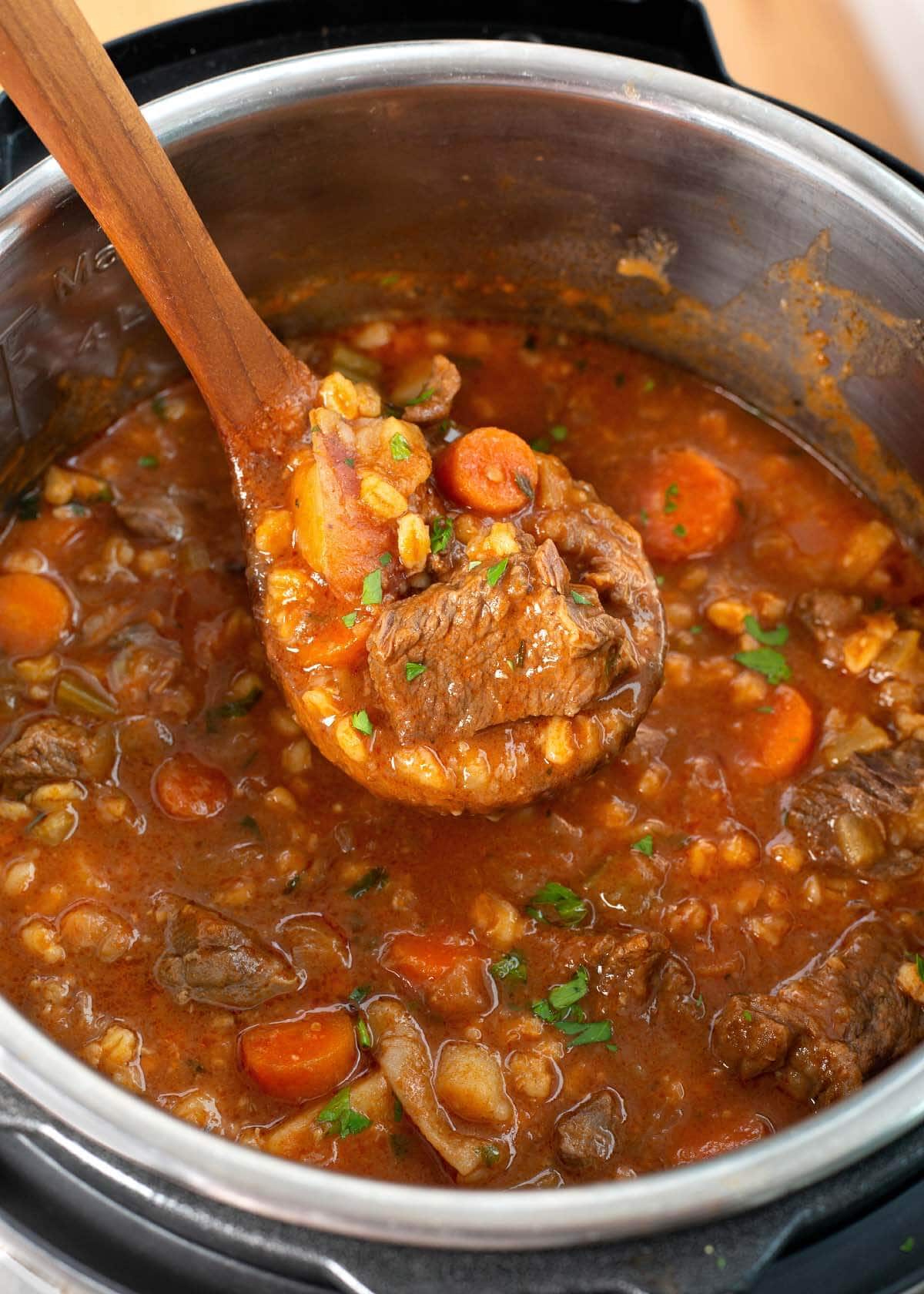 wood spoon with instant pot beef stew in it.