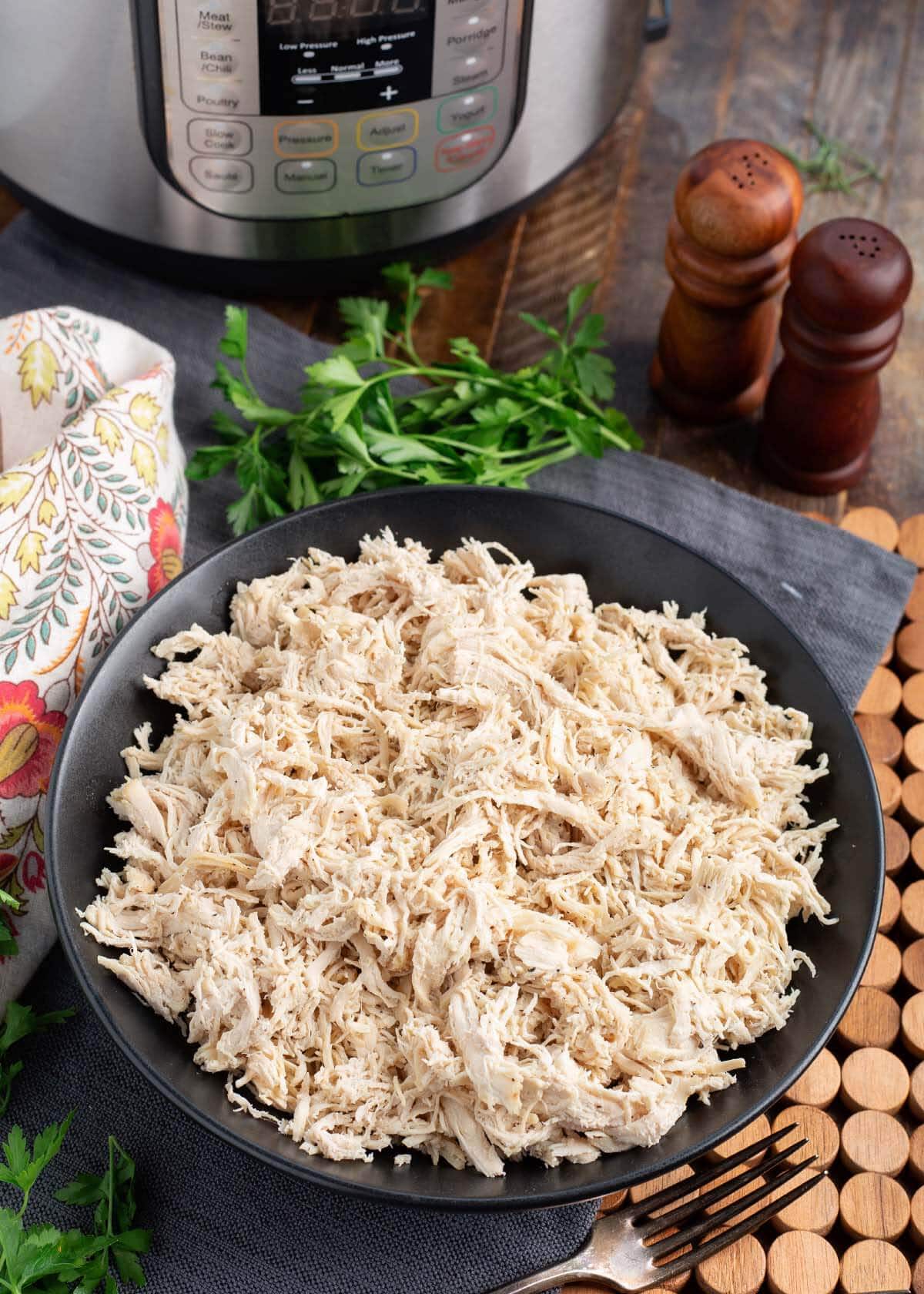 Instant Pot Shredded Chicken in a black bowl.