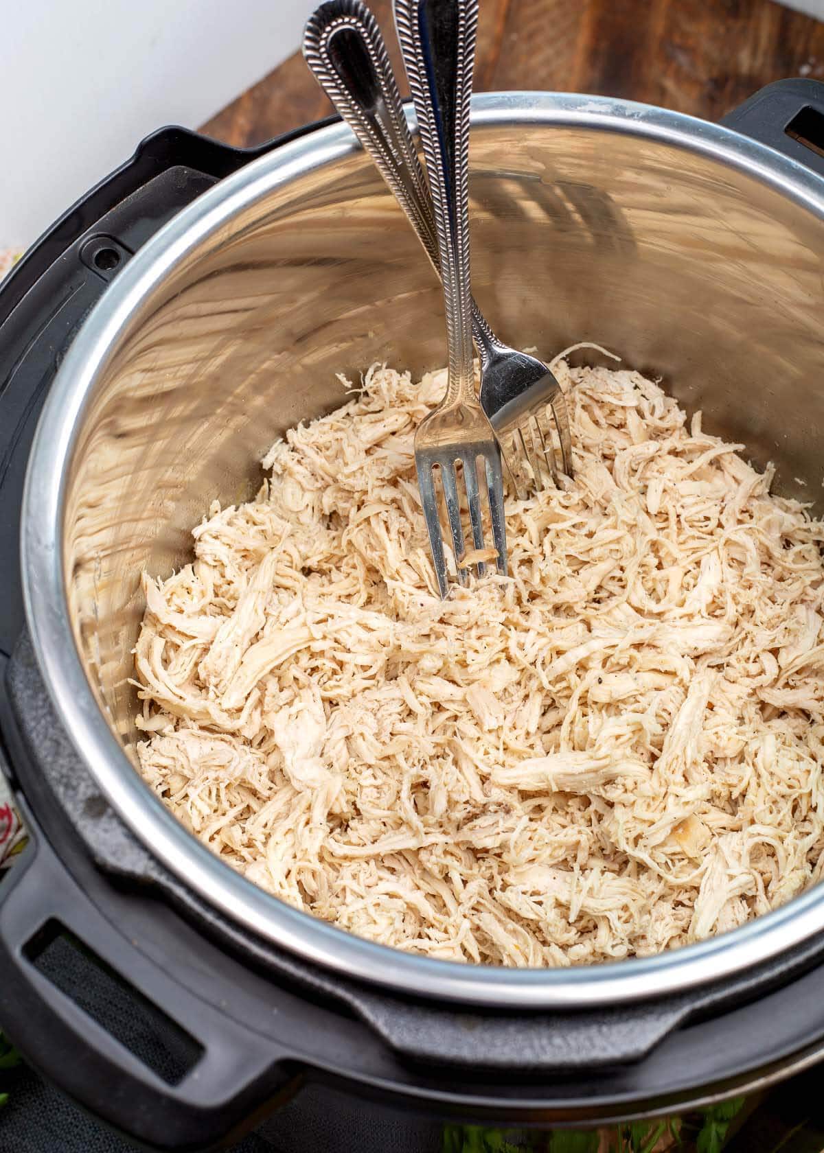 Shredded Chicken in the IP with 2 forks.