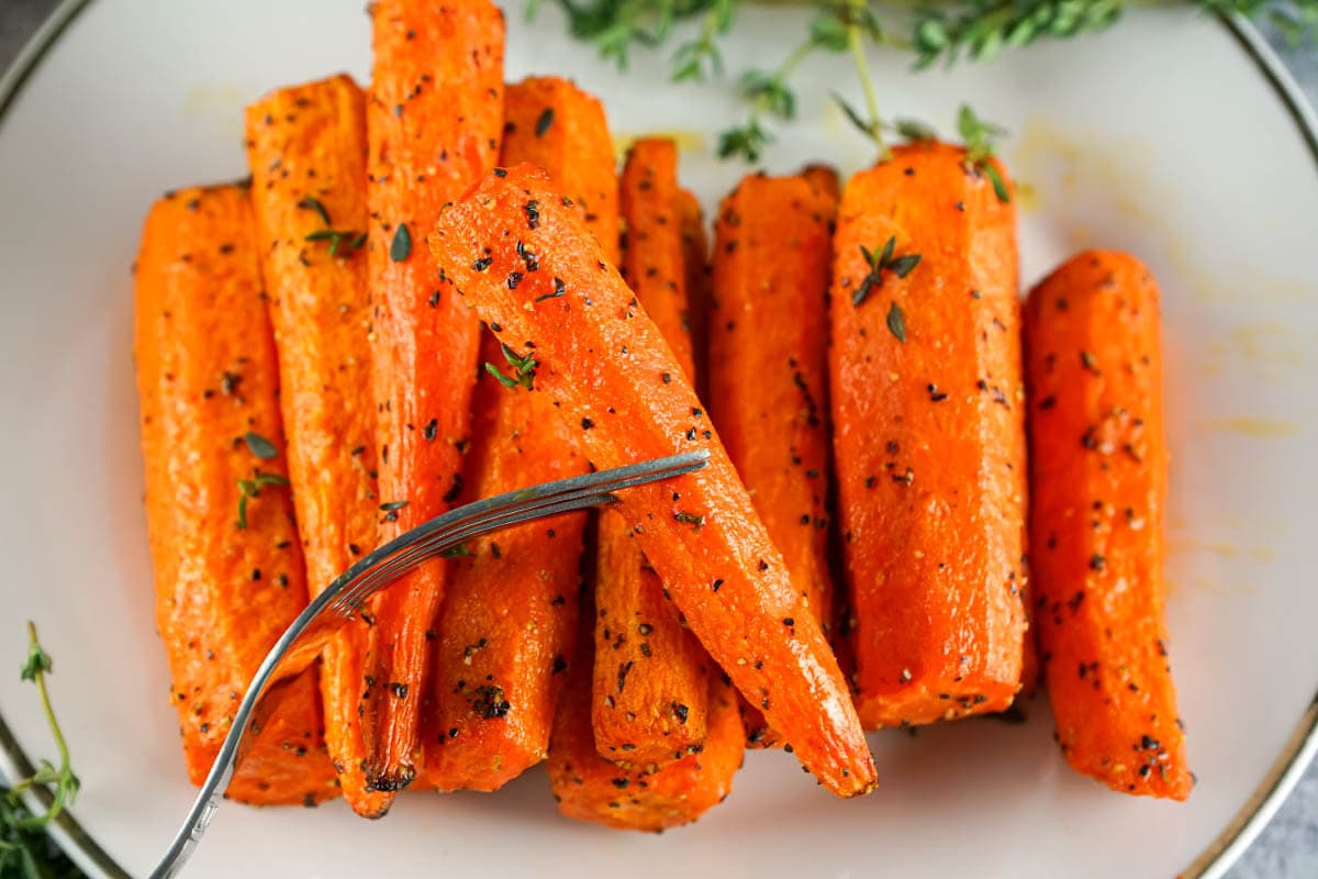 Carrots on plate and fork.