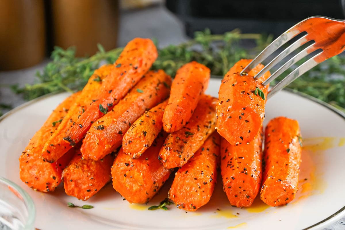 Air Fryer Carrots on plate with fork.