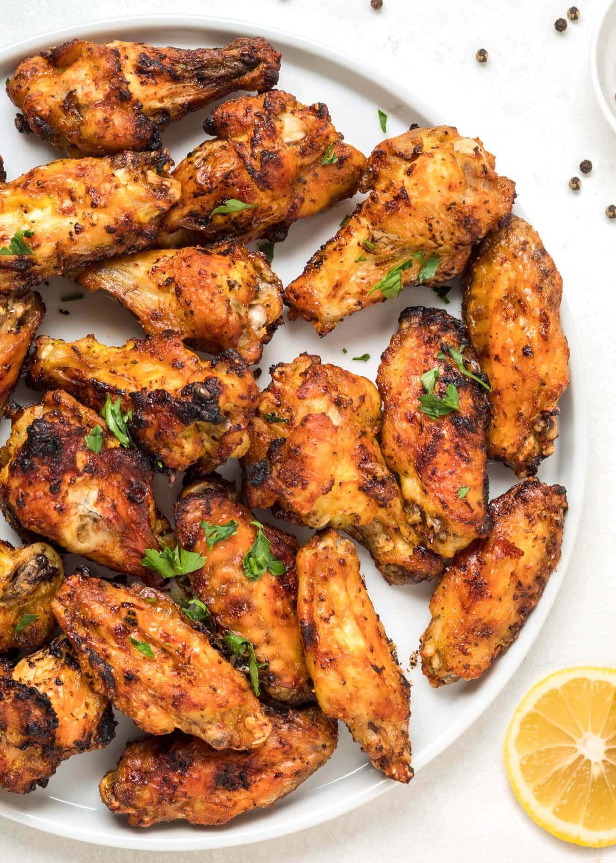 Air Fryer Lemon Pepper Chicken Wings on a plate.