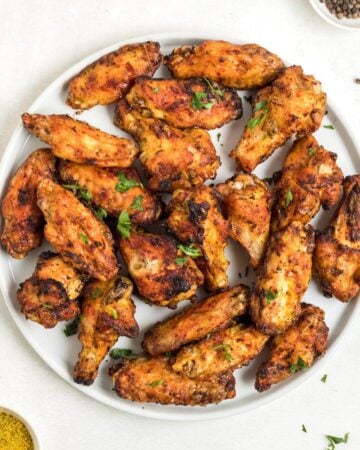 Air Fryer Lemon Pepper Chicken Wings on a plate.