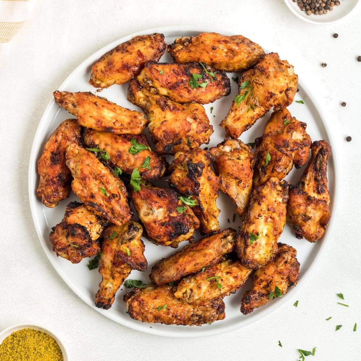 Air Fryer Lemon Pepper Chicken Wings on a plate.