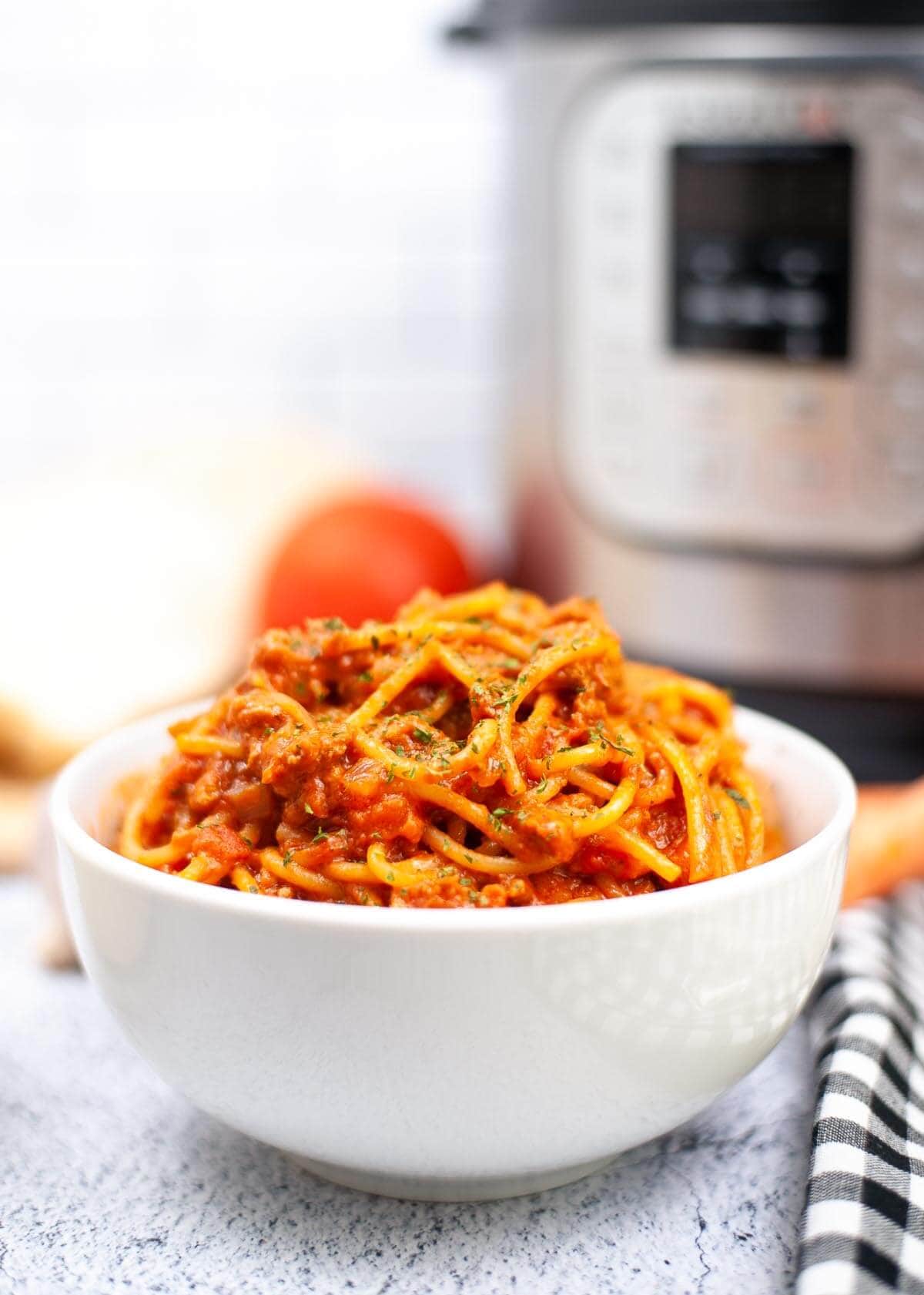 bowl of Spaghetti Bolognese in front of an IP.