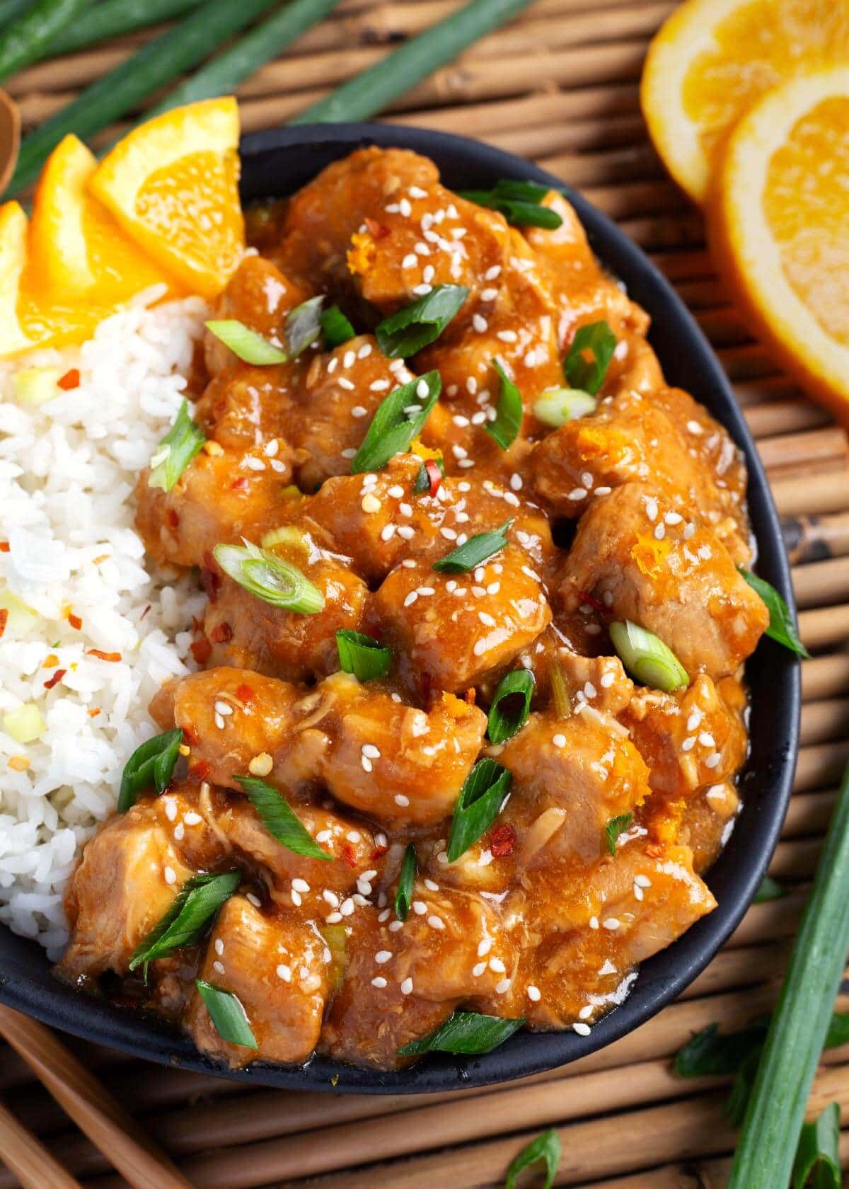 Instant Pot Orange Chicken in black dish closeup.