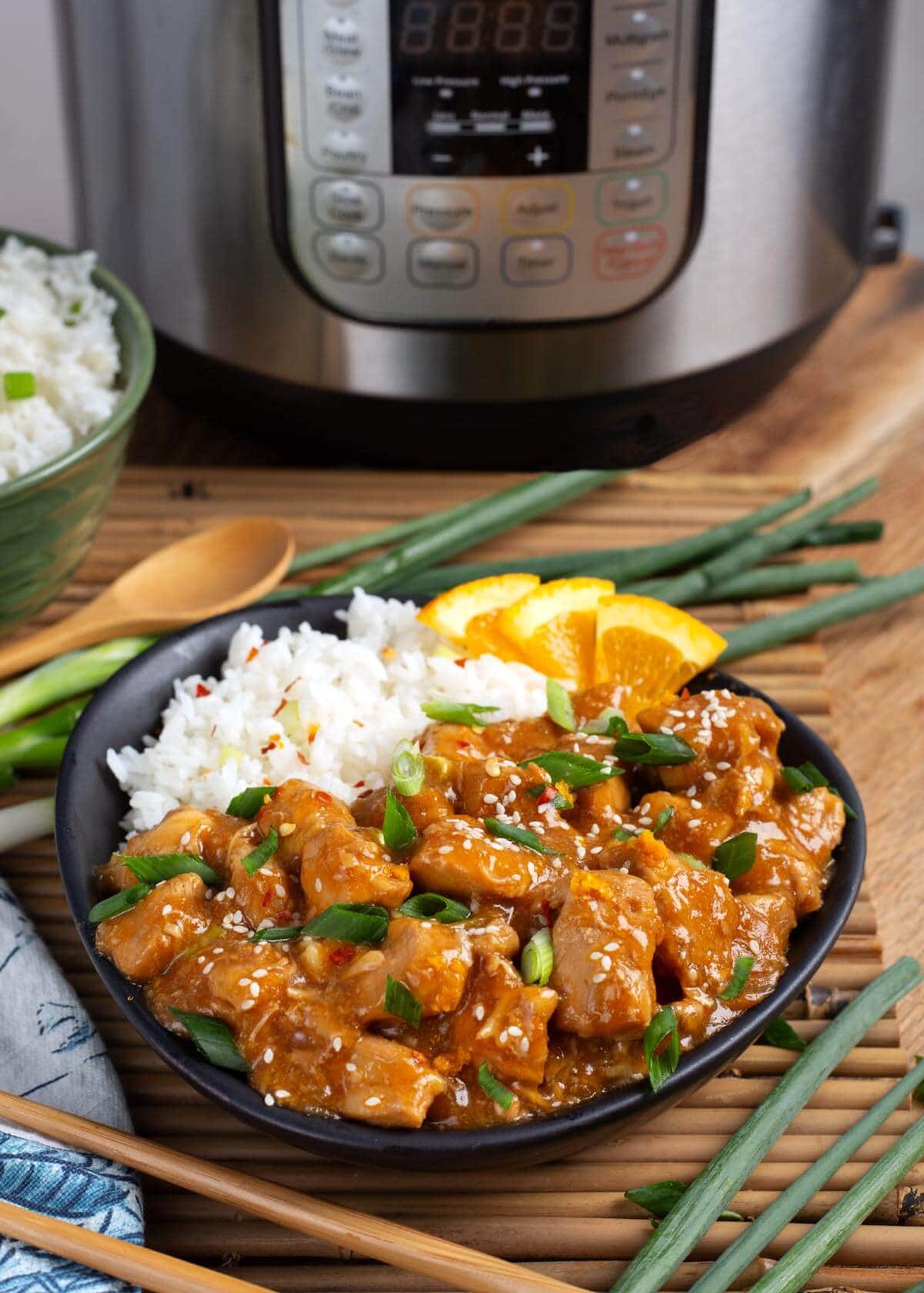 Orange Chicken in black dish in front of IP.