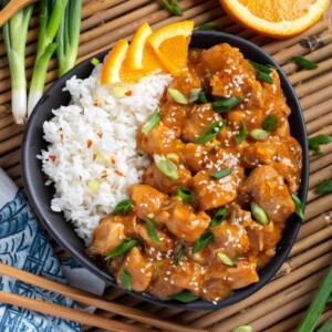 Instant Pot Orange Chicken in black dish.