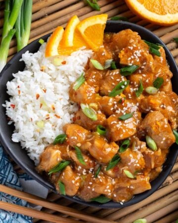 Instant Pot Orange Chicken in black dish.