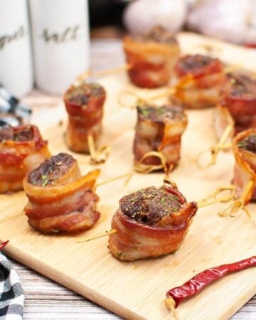 Air Fryer Bacon Wrapped Steak Bites on a board.