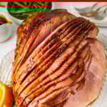 sliced crock pot ham on a white plate
