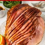 sliced slow cooker ham on white plate