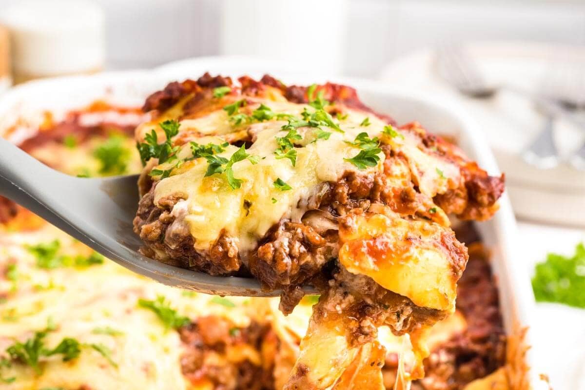 Ravioli Lasagna with Meat Sauce on a serving spoon.