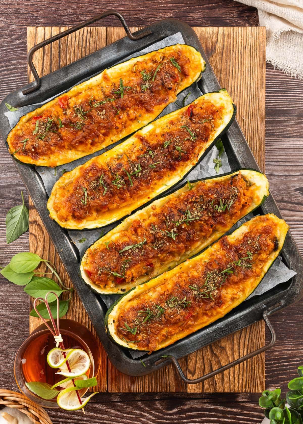 Cheesy Stuffed Zucchini Boats on a board.