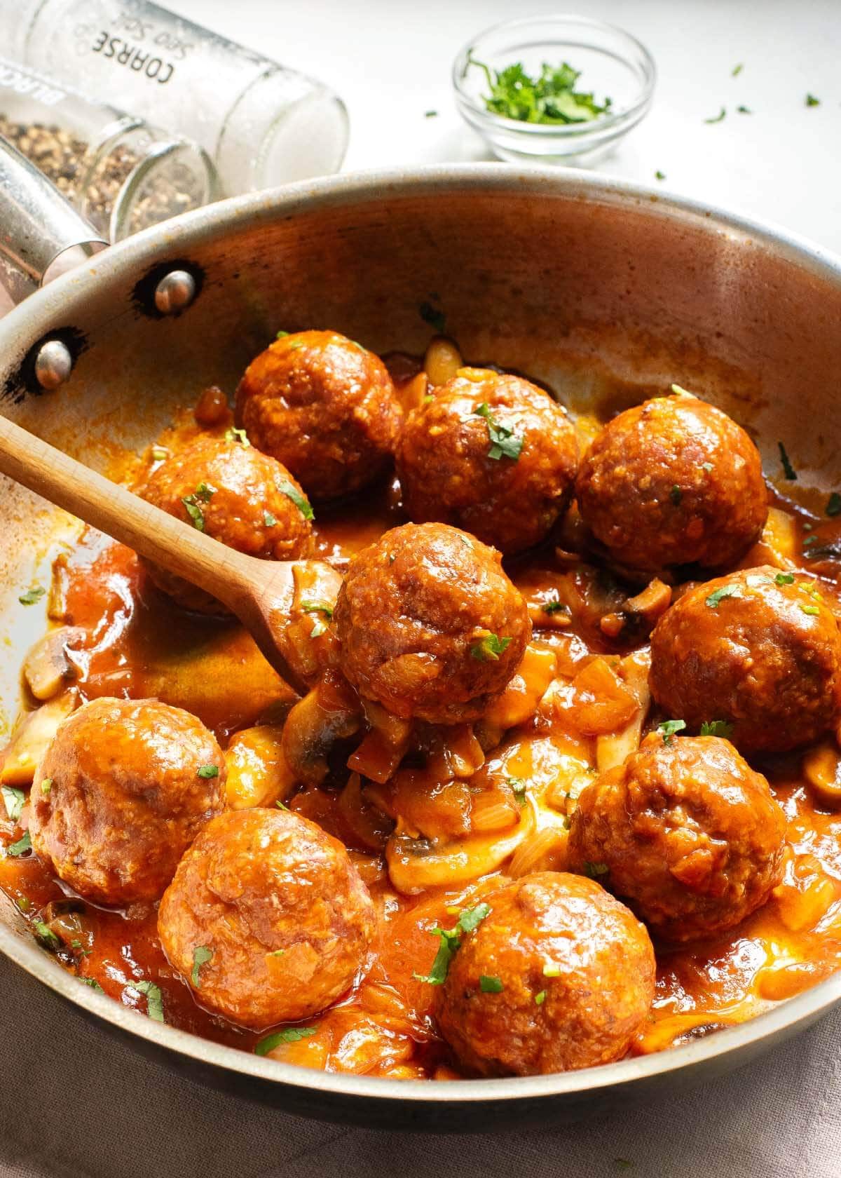 Salisbury Steak Meatballs in skillet with spoon.