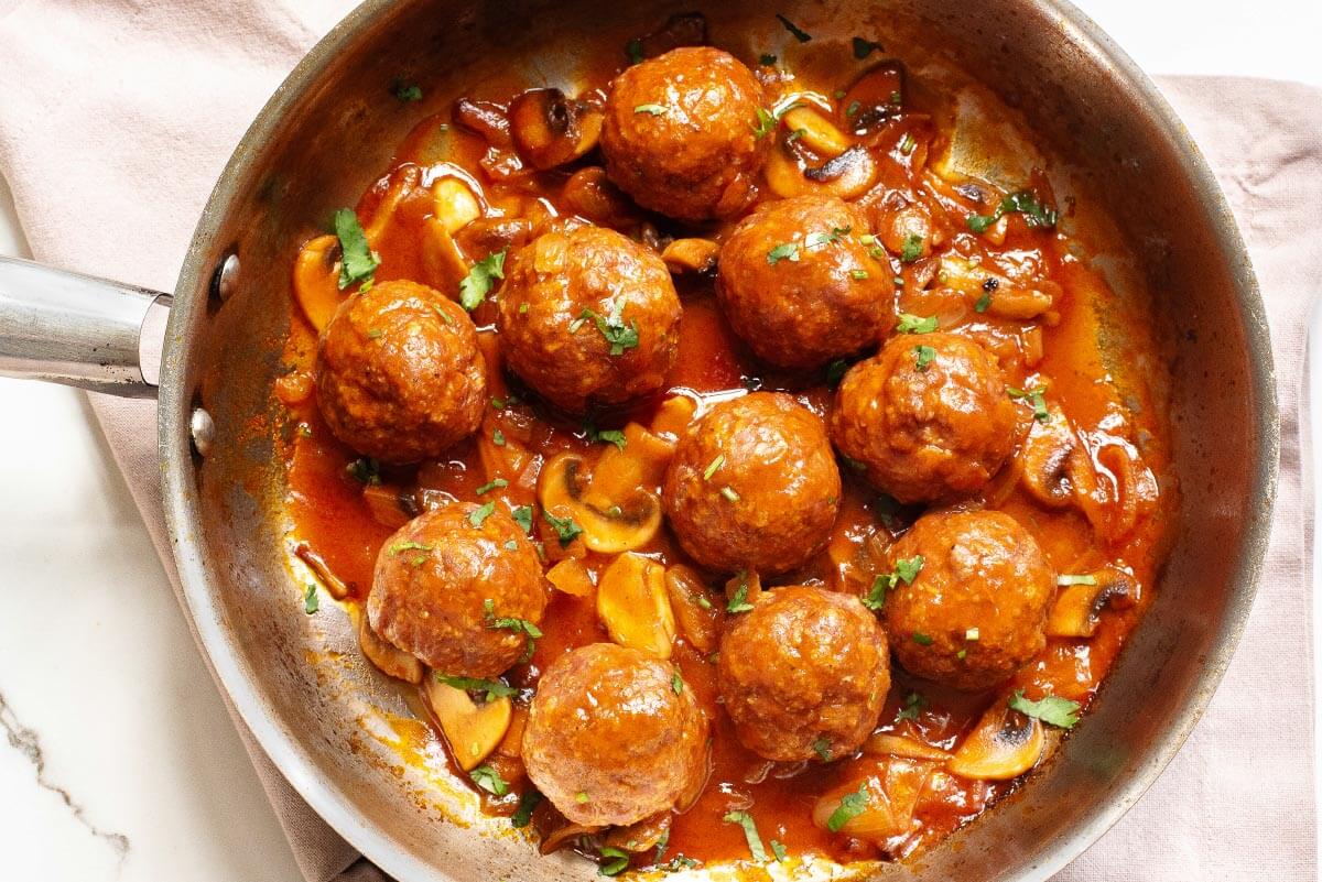 Salisbury Steak Meatballs and gravy in a skillet.