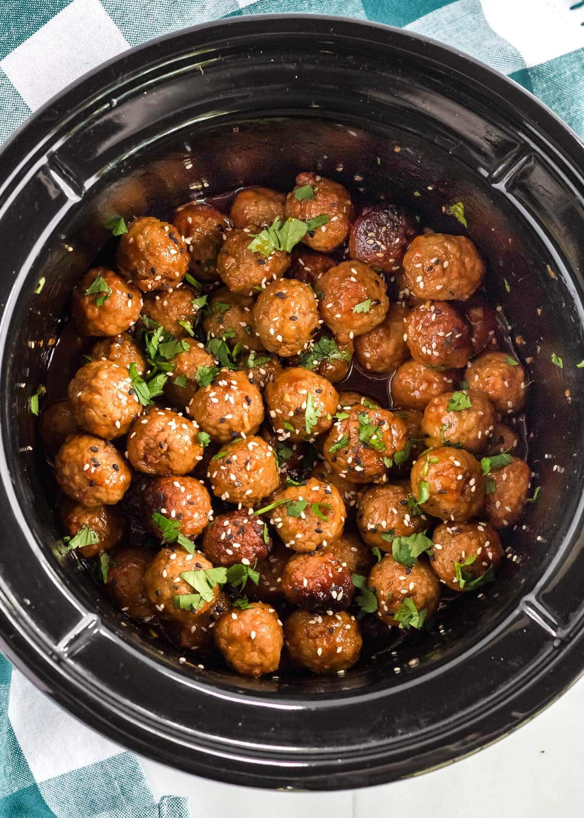 Slow Cooker Honey Garlic Meatballs in a black crock