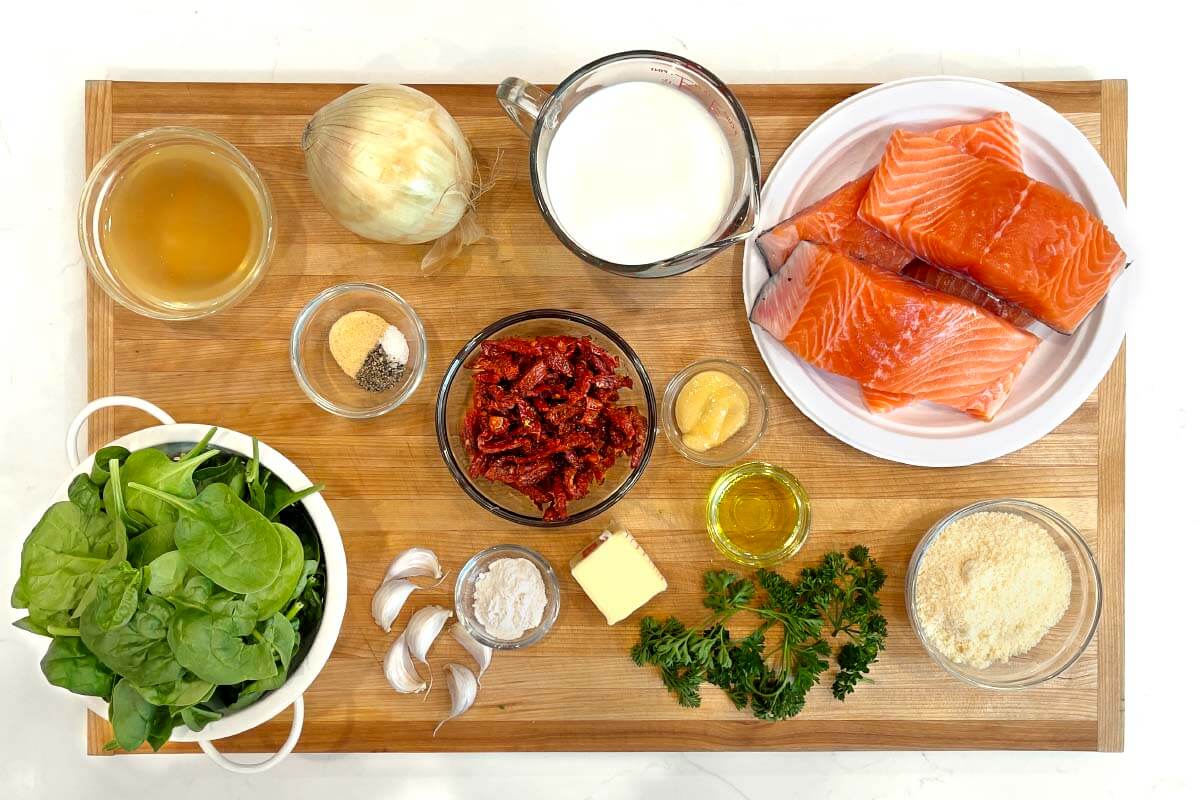 Creamy Garlic Tuscan Salmon ingredients shot on a board.