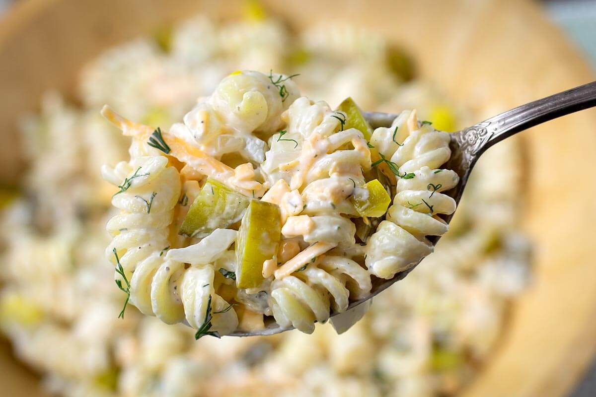 Dill Pickle Pasta Salad on a spoon.