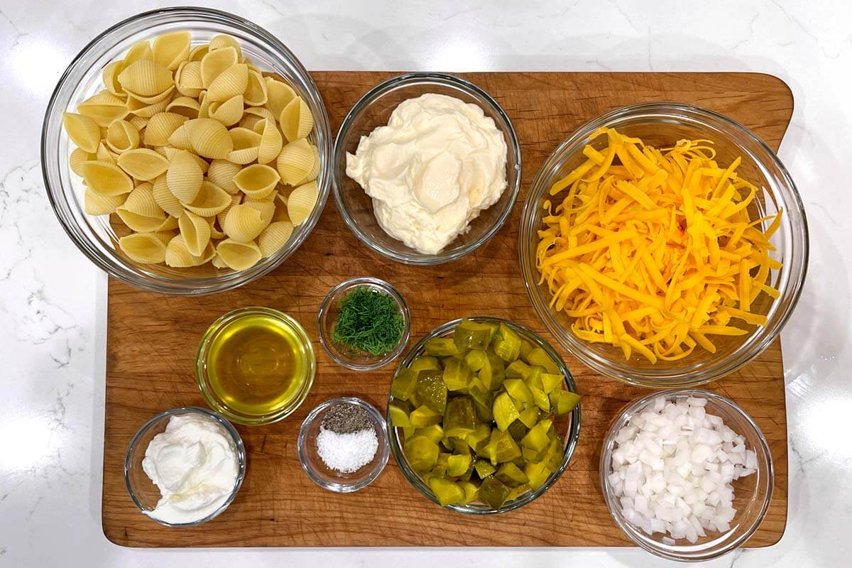 Dill Pickle Pasta Salad ingredients shot on board.