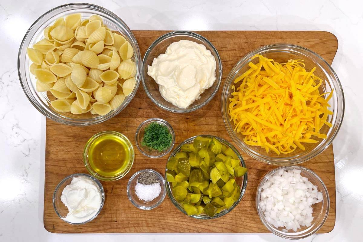 Dill Pickle Pasta Salad ingredients shot on board.