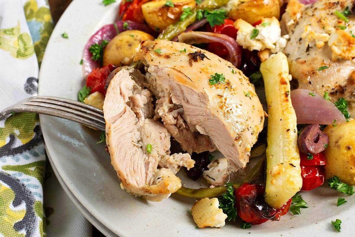 Greek Sheet Pan Chicken Dinner closeup of chicken thigh
