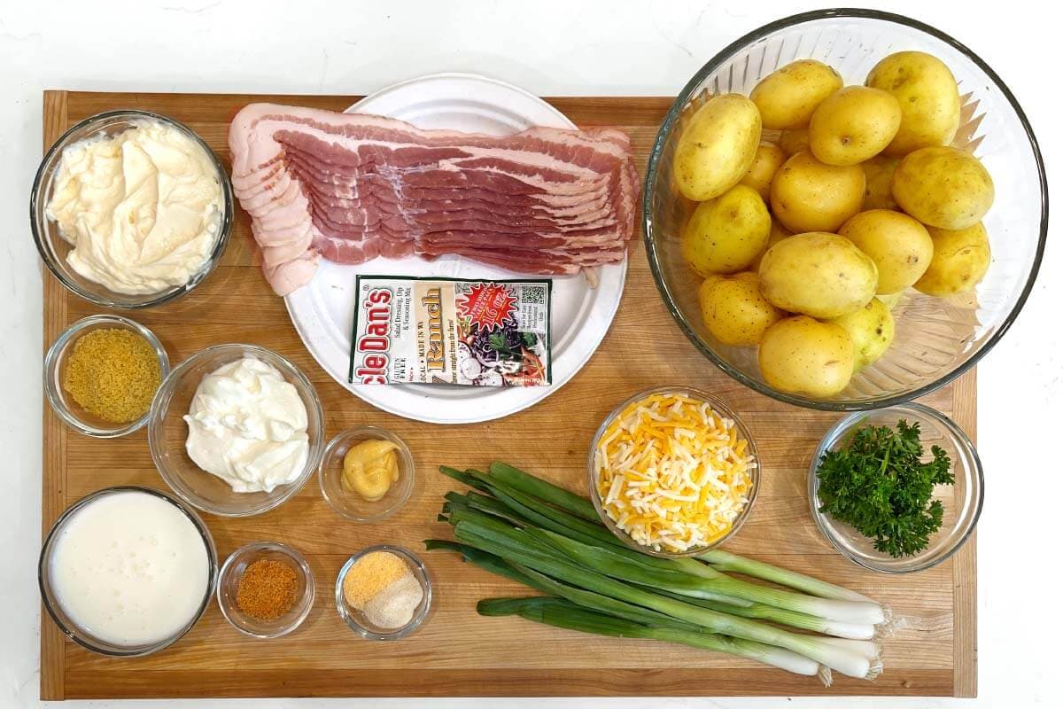 Loaded Potato Salad ingredients on a board