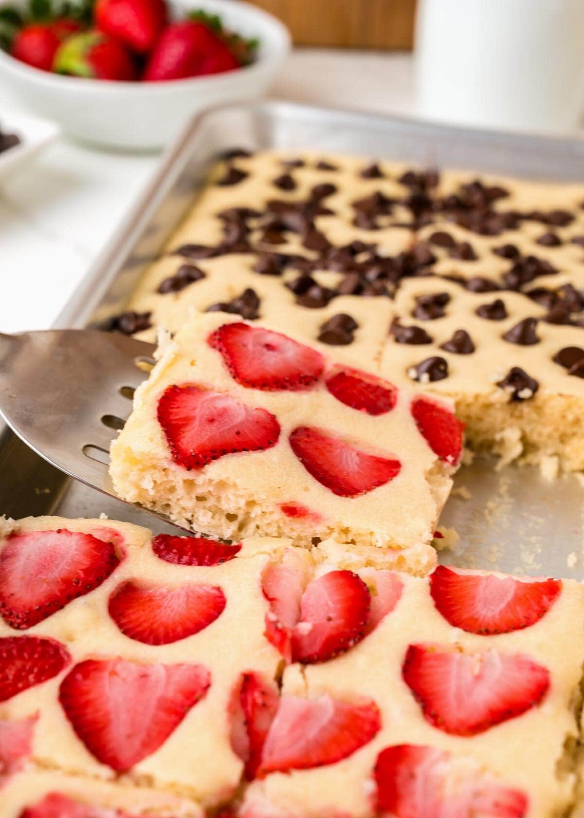 Sheet Pan Pancakes with a serving on a spatula.