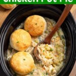 Slow Cooker Chicken Pot Pie in crock with ladle & biscuits