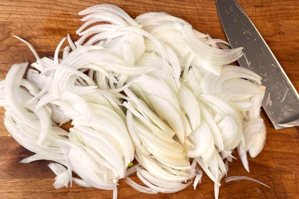 sliced onions on a board.