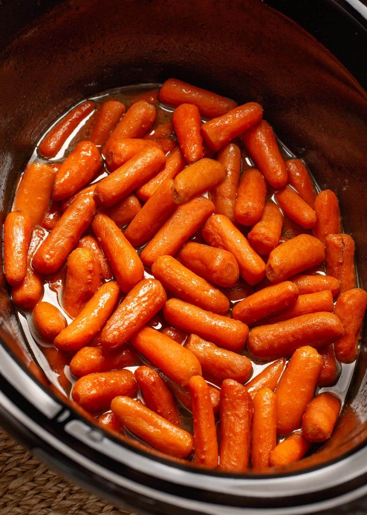 Slow Cooker Maple Brown Sugar Carrots in black crock