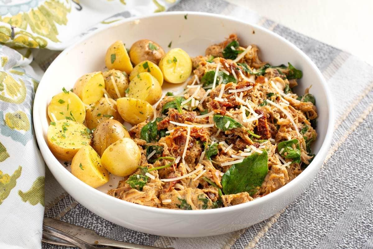 Slow Cooker Marry Me Chicken in a white bowl.