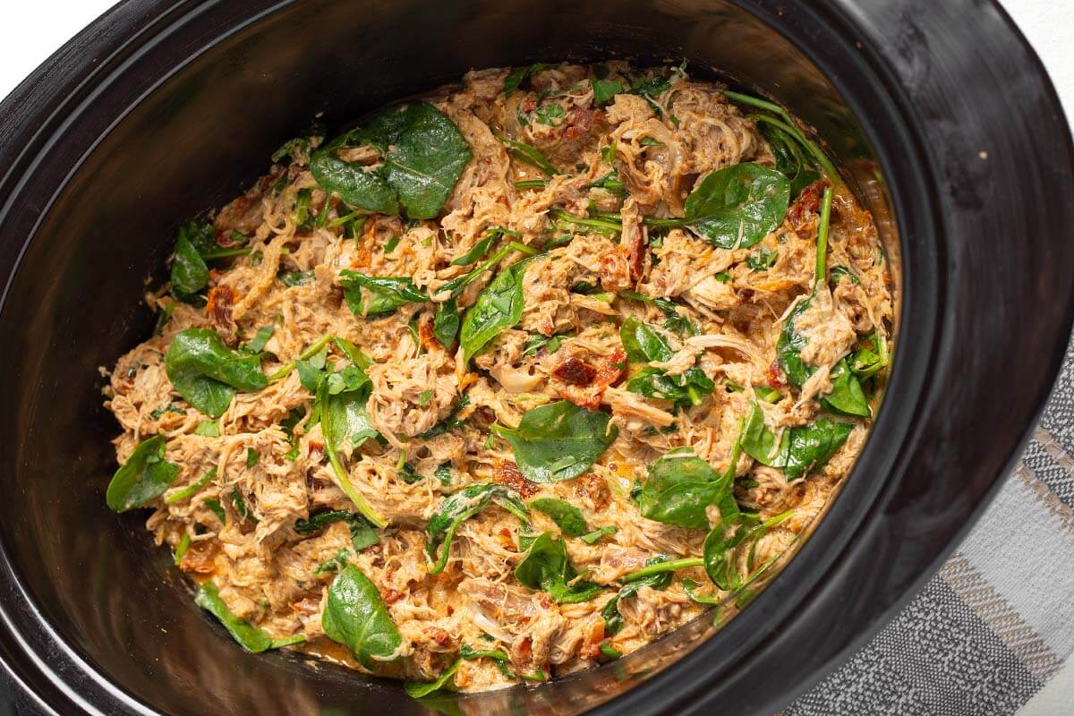 Slow Cooker Marry Me Chicken in a black crock.