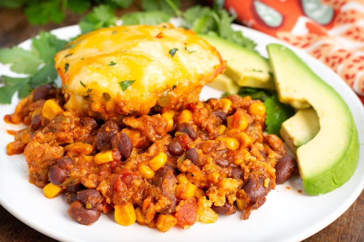 Slow Cooker Tamale Pie on a white plate with garnish.