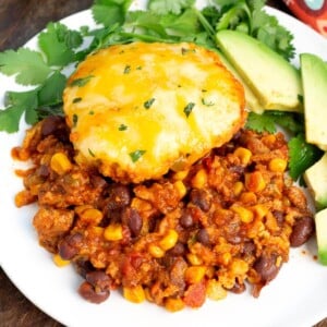 Slow Cooker Tamale Pie on a white plate with garnish.