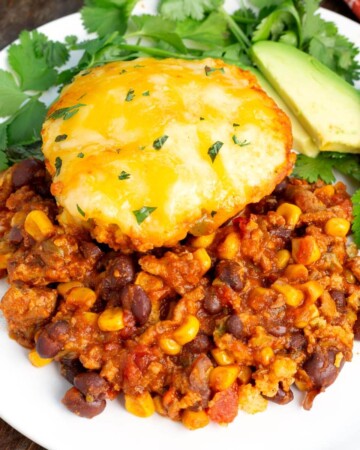 Slow Cooker Tamale Pie on a white plate with garnish.