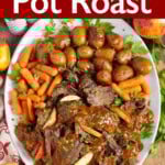 Apple Cider Pot Roast on a white platter with carrots and potatoes.
