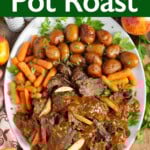 Apple Cider Pot Roast on a white platter with carrots and potatoes.