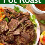 Apple Cider Pot Roast on a white platter with carrots and potatoes.