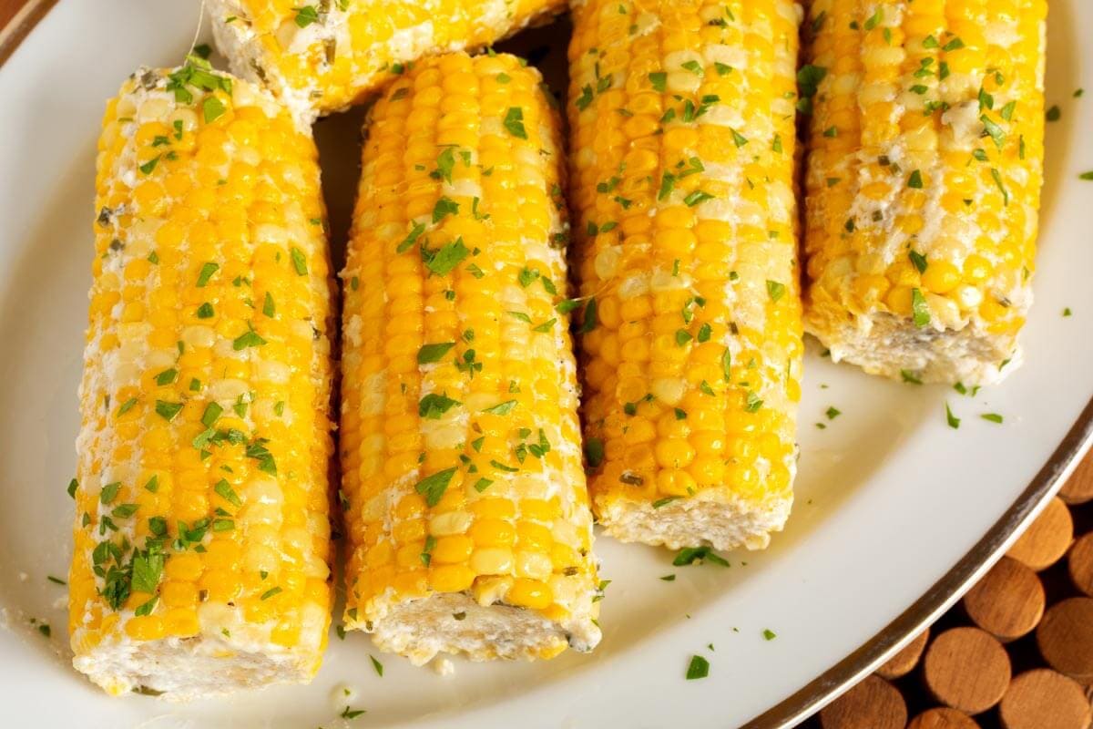 5 Corn on the Cob on a white plate