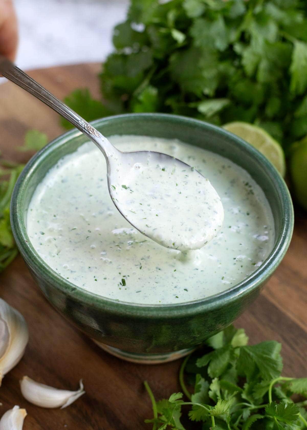Cilantro Cream Sauce in a green bowl with a spoon