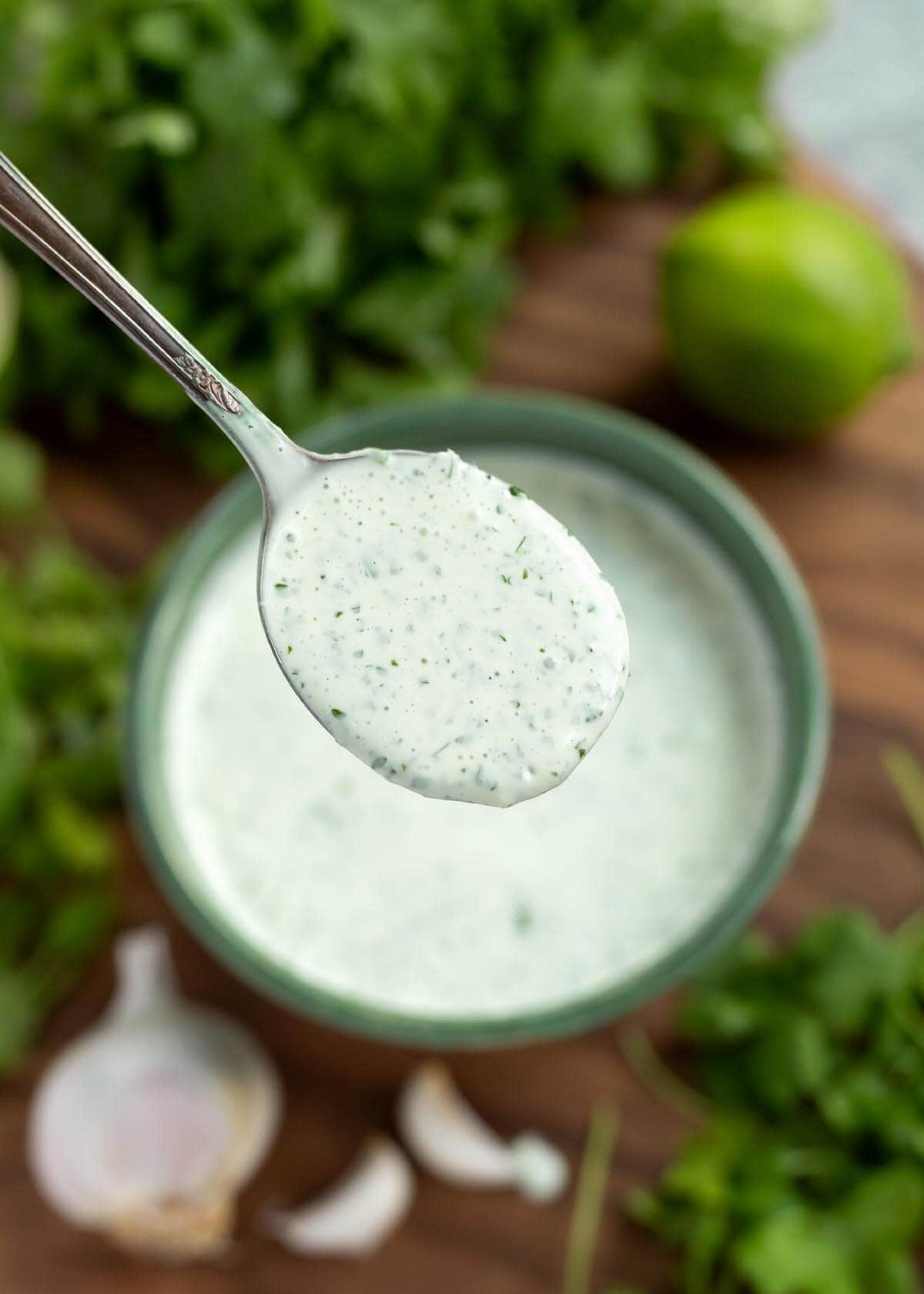 Cilantro Cream Sauce in a green bowl with a spoon