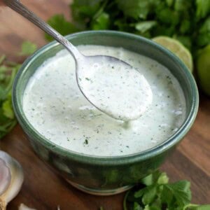 Cilantro Cream Sauce in a green bowl with a spoon