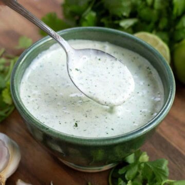 Cilantro Cream Sauce in a green bowl with a spoon