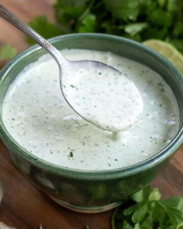 Cilantro Cream Sauce in a green bowl with a spoon
