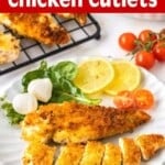 Crispy Pan-Fried Chicken Cutlets on a white plate with salad