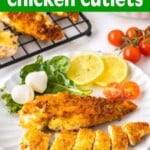 Crispy Pan-Fried Chicken Cutlets on a white plate with salad