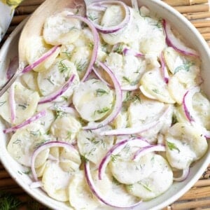 Creamy Dill Cucumber Salad in a white bowl closeup.