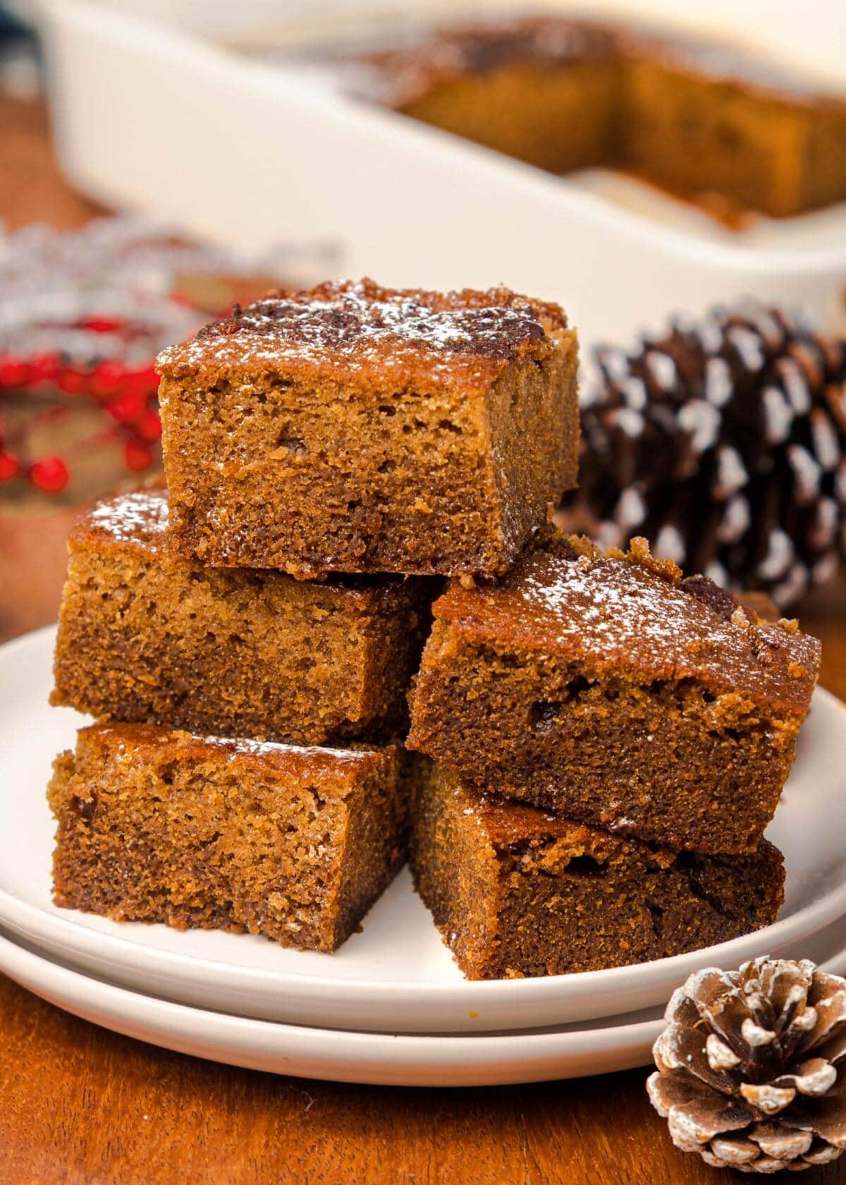 5 pieces of Old-Fashioned Gingerbread Cake on a white plate.