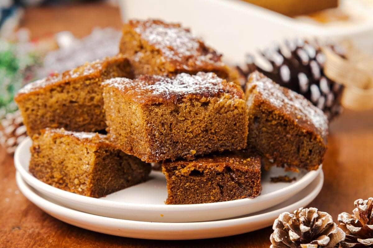 5 pieces of Old-Fashioned Gingerbread Cake on a white plate.